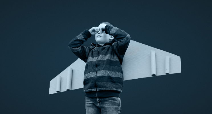 child with plane wings on its shoulders